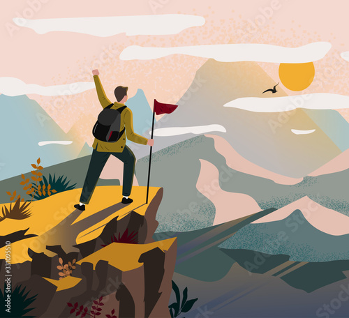 A traveler man on top of a mountain with a backpack and a flag triumphantly raised his hand and looking on valley. The concept of travel, hikes, discoveries, exploration, adventure tourism and travel