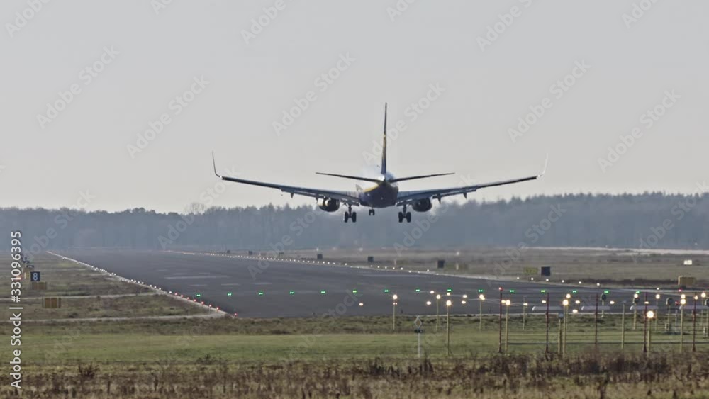 Slow motion shot of an airplane landing on a runway. Eindhoven, The Netherlands. Slow motion shot of an airplane landing on a runway. Eindhoven, The Netherlands.