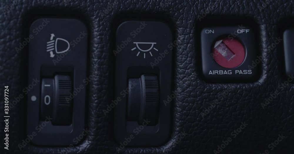 Car driver turns the passenger airbag on. Closeup handheld shot. Car driver turns the passenger airbag on. Closeup handheld shot.