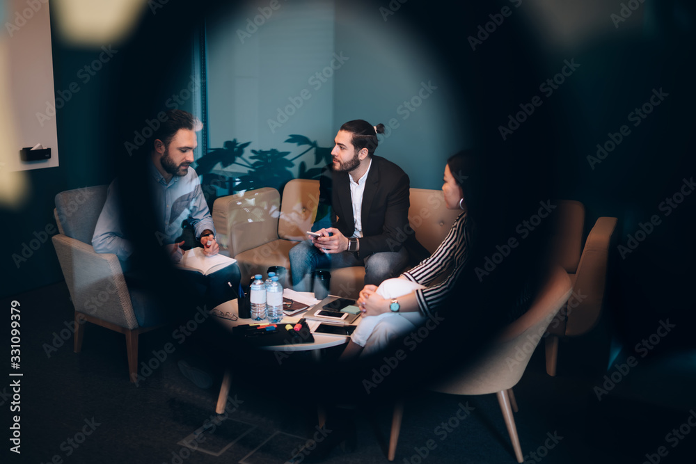 Successful group of coworkers discuss business ideas in rest room Successful group of coworkers discuss business ideas in rest room