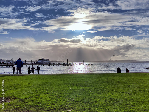 People walking by the beach at the Kirkland Marina at Lake Washington