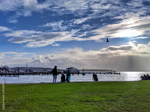 People walking by the beach at the Kirkland Marina at Lake Washington