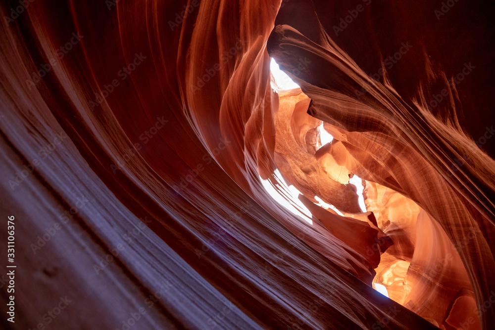 Obraz premium Unique & stunning Antelope Canyon located near Page, Arizona. Looking up into the famous tourist area during summer time with sun shining down through canyon walls 