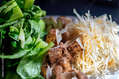 closup of cut bok choy, shitake muchrooms and enoki mushrooms photo
