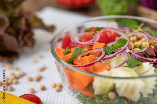 Fruit and vegetable salad in a glass cup on a white ground