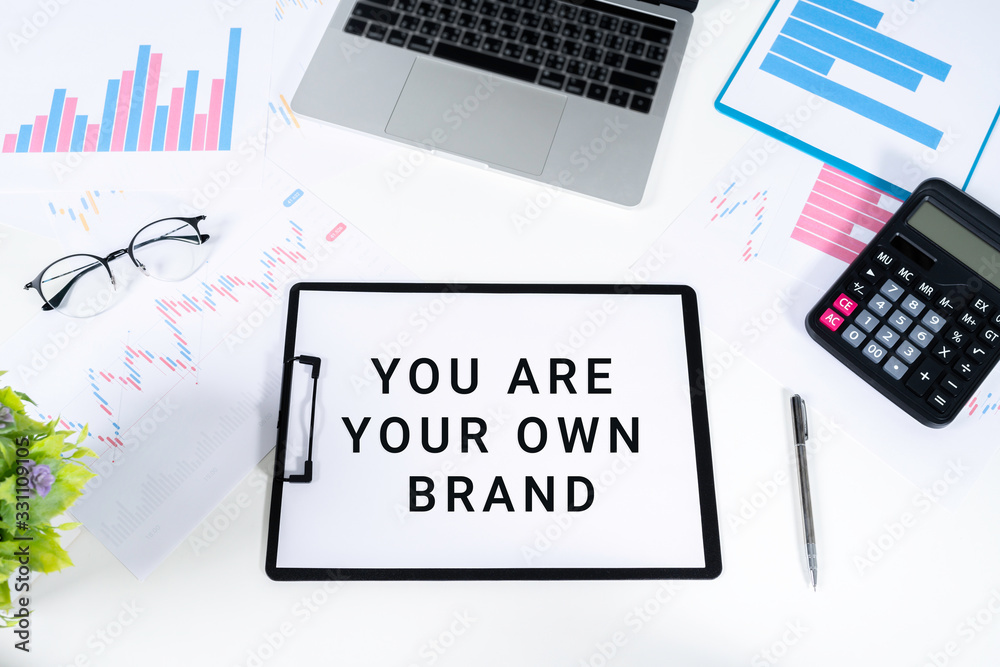 Obraz premium Top view of documents written with YOU ARE YOUR OWN BRAND Brand Building concept.