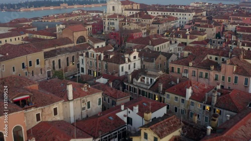 Aerial, tilt, drone shot over buildings and architecture, on a evening, in Venice, Italy photo