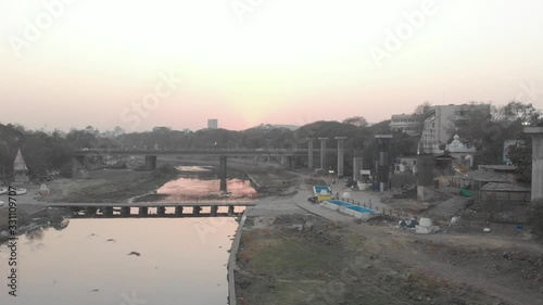 Rising drone shot over Pune city at sunset photo