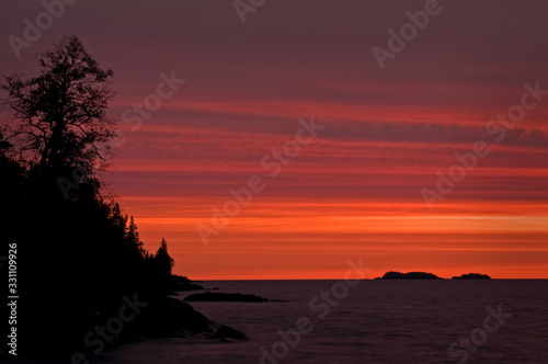 Sunrise Sunrise colors reflect off the waters of Rock Harbor at Isle Royale National Park  Michigan.