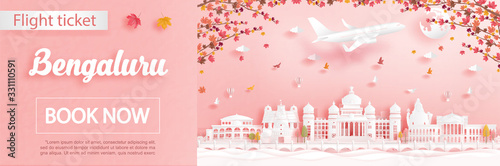 Flight and ticket advertising template with travel to Bengaluru, India in autumn season deal with falling maple leaves and famous landmarks in paper cut style vector illustration