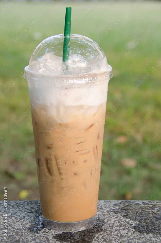 Iced coffee on the marble table in the park Iced coffee on the marble table in the park