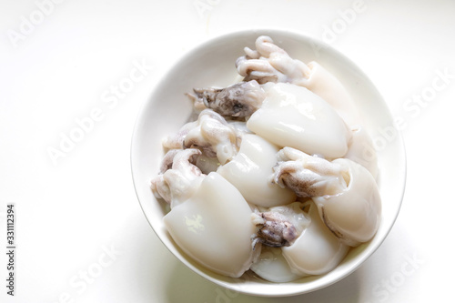 Raw Cuttlefish or Cuttlefish Rainbow in a bowl isolated on white background. photo