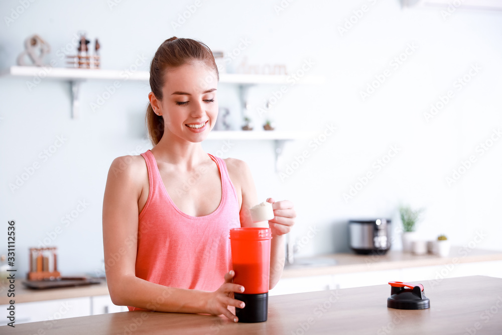 Sporty young woman making protein shake at home Sporty young woman making protein shake at home