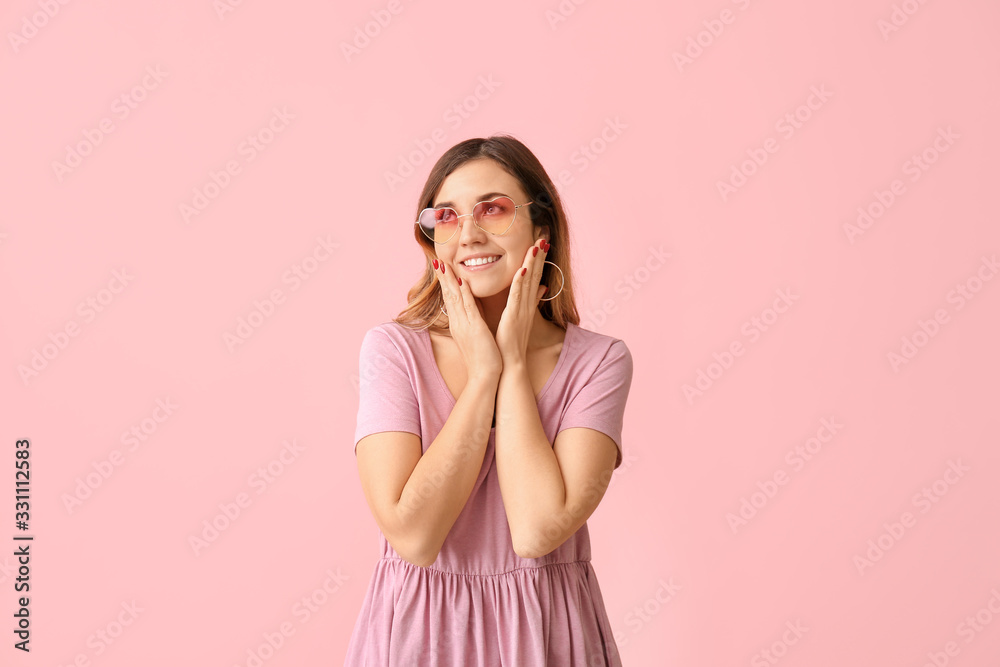 Young woman with stylish sunglasses on color background Young woman with stylish sunglasses on color background