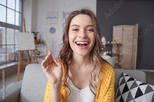 Young woman using video chat at home