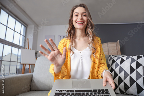 Young woman using video chat at home photo