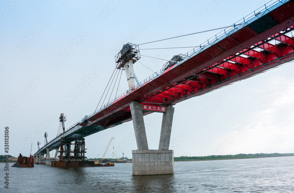 Fototapeta premium Russia, Blagoveshchensk, July 2019: Bridge on the Amur river from Blagoveshchensk to the Chinese city of Heihe in summer