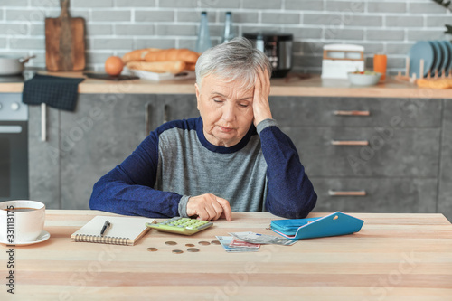 Senior woman counting money...