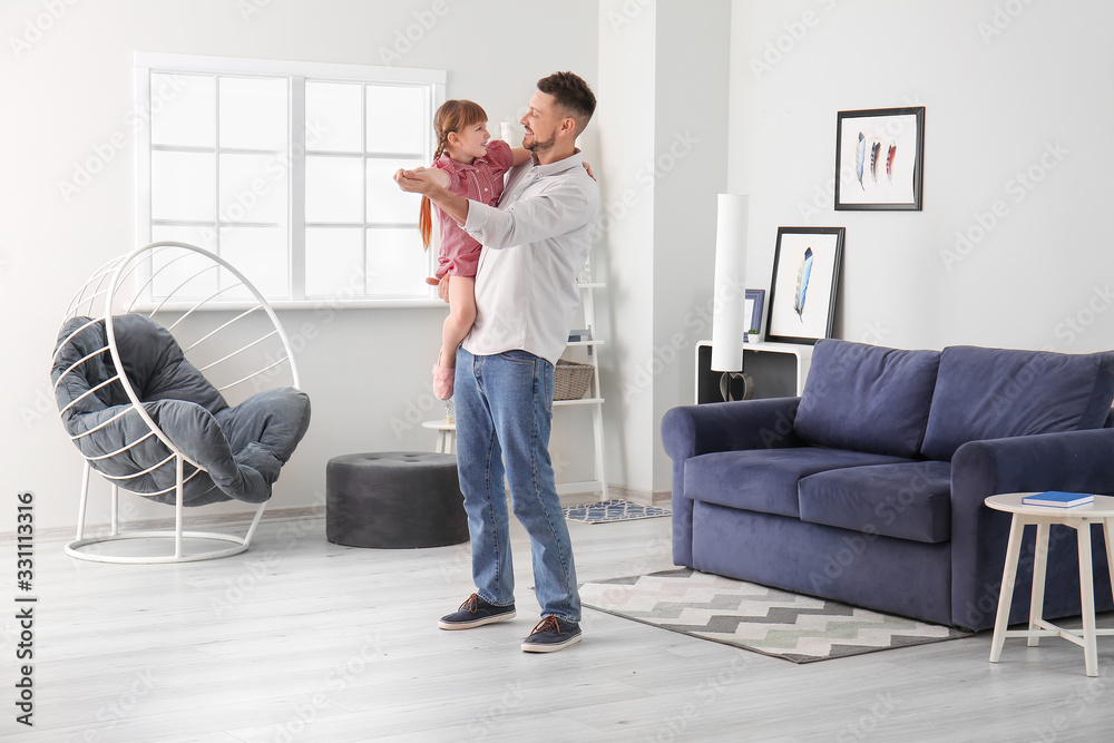Father and his little daughter dancing at home Father and his little daughter dancing at home