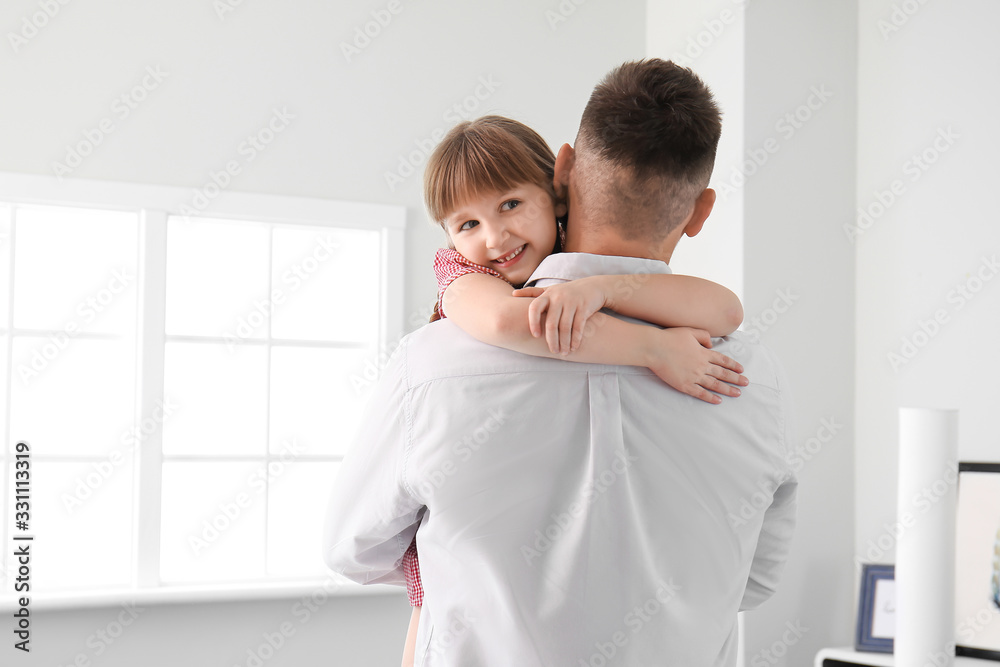 Happy father and his little daughter hugging at home Happy father and his little daughter hugging at home