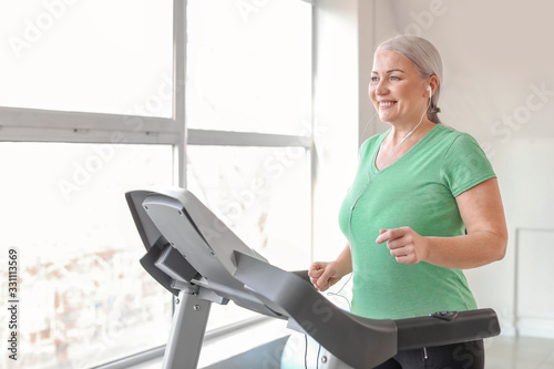 Sporty mature woman on trea...