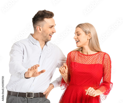 Happy dancing young couple on white background