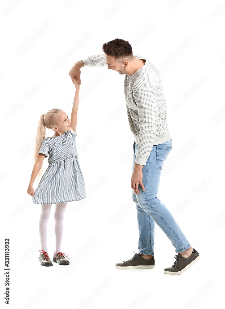 Man and his little daughter dancing against white background Man and his little daughter dancing against white background