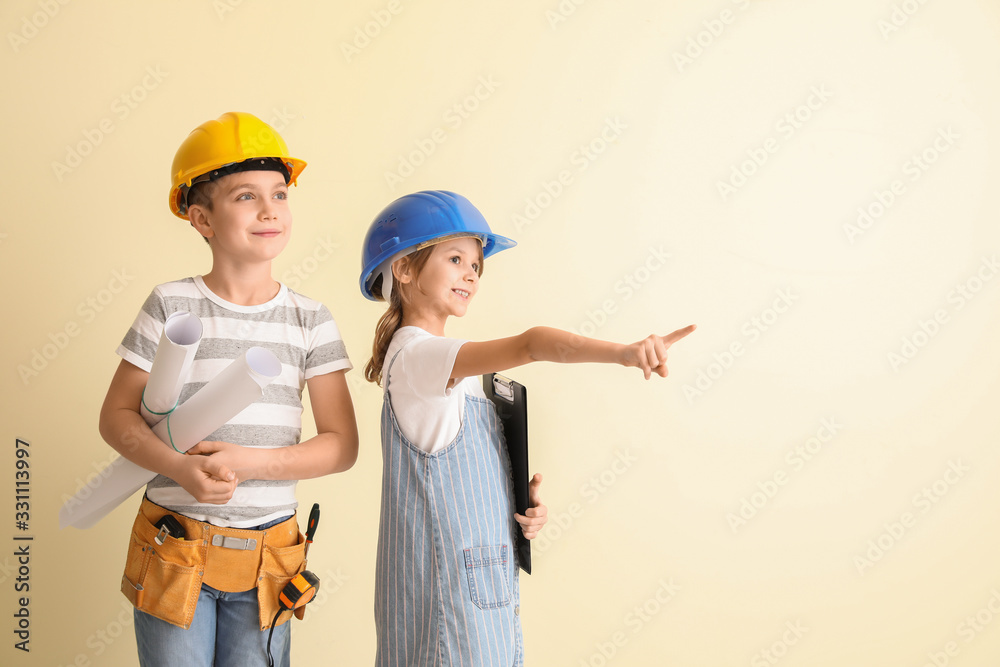 Cute little architects on light background Cute little architects on light background