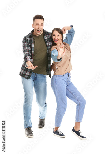 Young couple dancing against white background