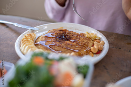 breakast with Banana pancake,honey ,carrot and vegetable photo