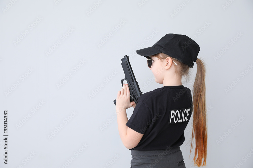 Cute little police officer on light background Cute little police officer on light background