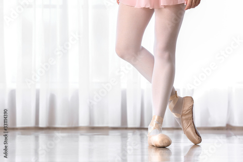 Legs of beautiful young ballerina in dance studio
