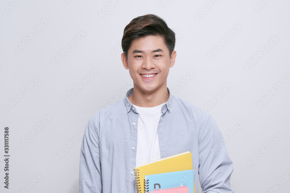 Young asian woman isolated on white wall studio casual daily lifestyle student holding notebooks smiling Young asian woman isolated on white wall studio casual daily lifestyle student holding notebooks smiling