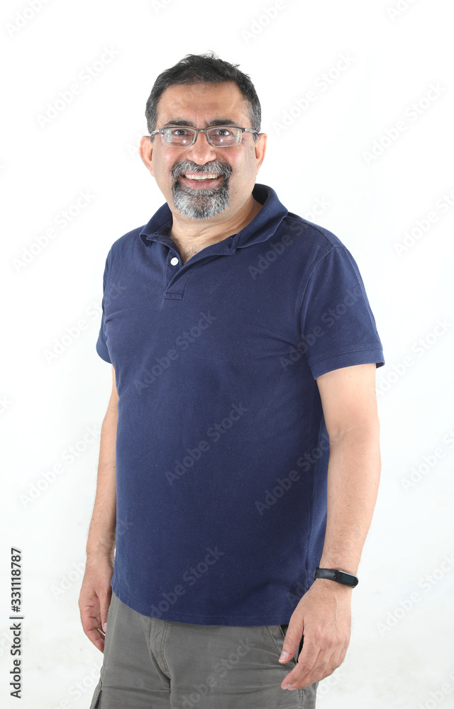 A smiling Indian man with a goatee beard wearing spectacles against a white background. looking to camera. A smiling Indian man with a goatee beard wearing spectacles against a white background. looking to camera.
