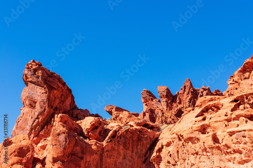 Fantastic aztec sandstone rock formations in the Valley of Fire state park under beautiful blue sky