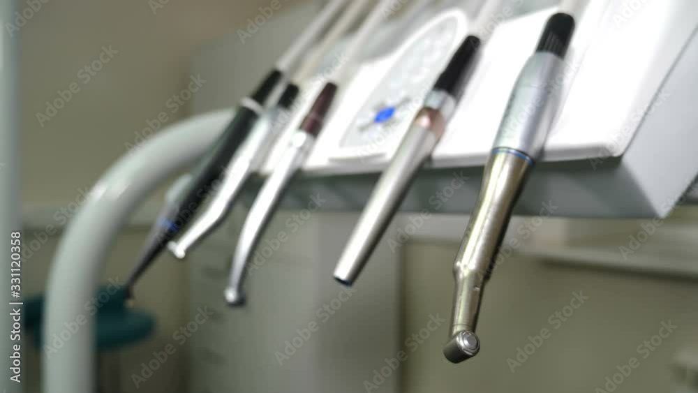 Dental clinic: room with dental medical equipment on console. Set of drills placed on dental instrument panel. Close-up. Tools for dental care. Office, Tools, Instruments,supplies. 4 k shot Dental clinic: room with dental medical equipment on console. Set of drills placed on dental instrument panel. Close-up. Tools for dental care. Office, Tools, Instruments,supplies. 4 k shot