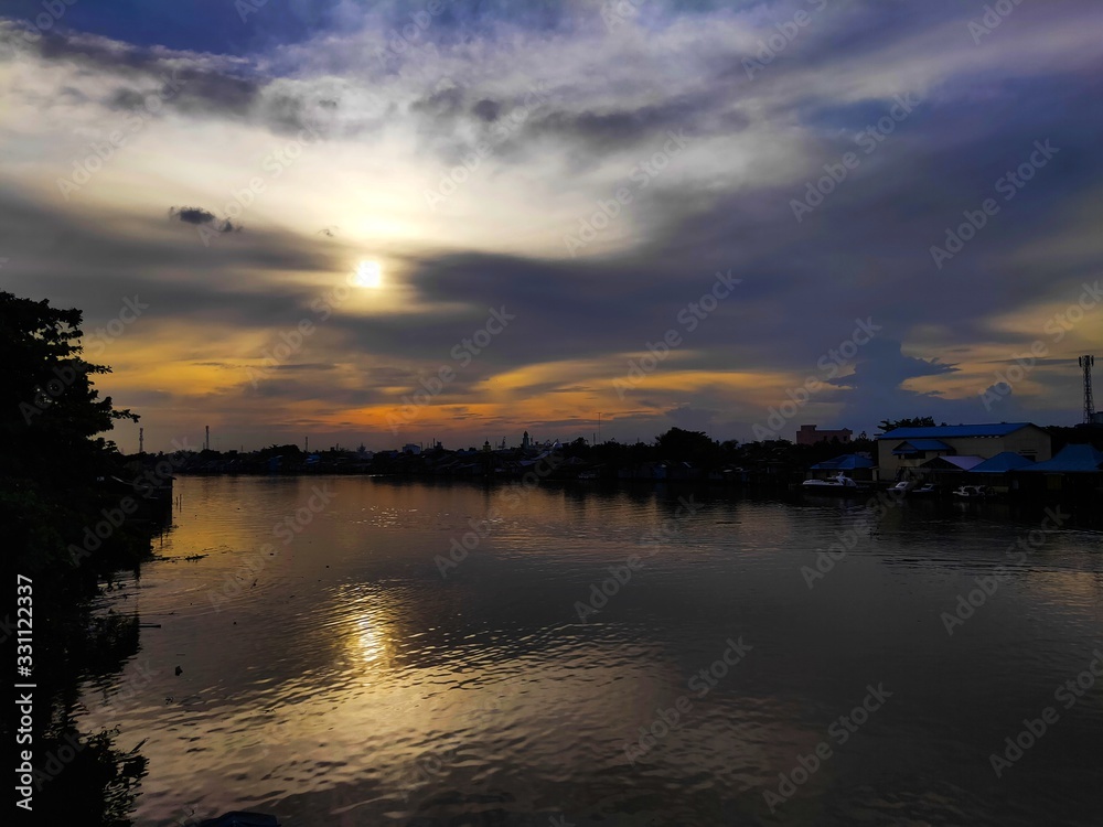 Blue and Orange Sky of Sunset Views at Martapura River in Afternoon, Use as a Background and Wallpaper
