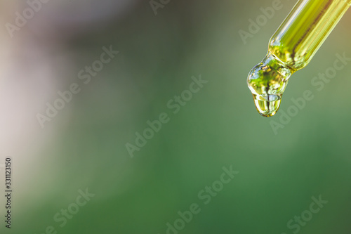 droplet dosing a biological and ecological hemp plant herbal pharmaceutical, cbd cannabis oil.