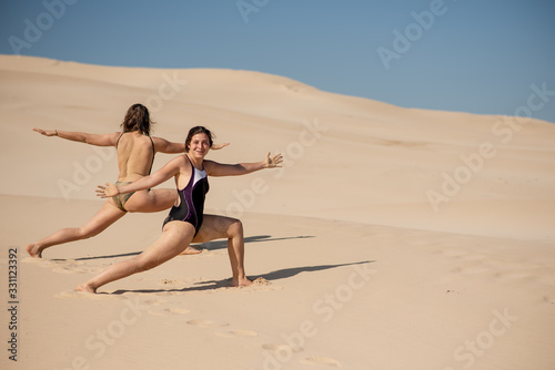 Two young ladies practicing at beach