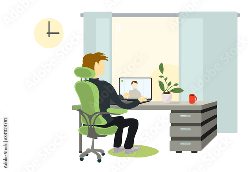 a man in a chair at the table is negotiating a video call. time for remote work