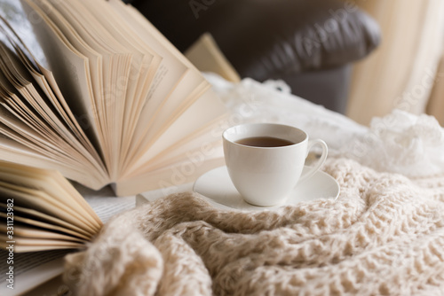  Books  on the bed and a cup of tea.