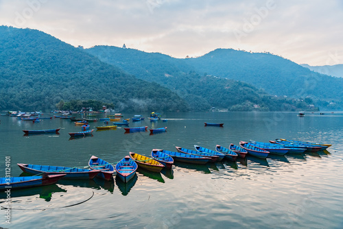 Beautiful view of boats docked at Phewa lake in Pokhara Nepal photo