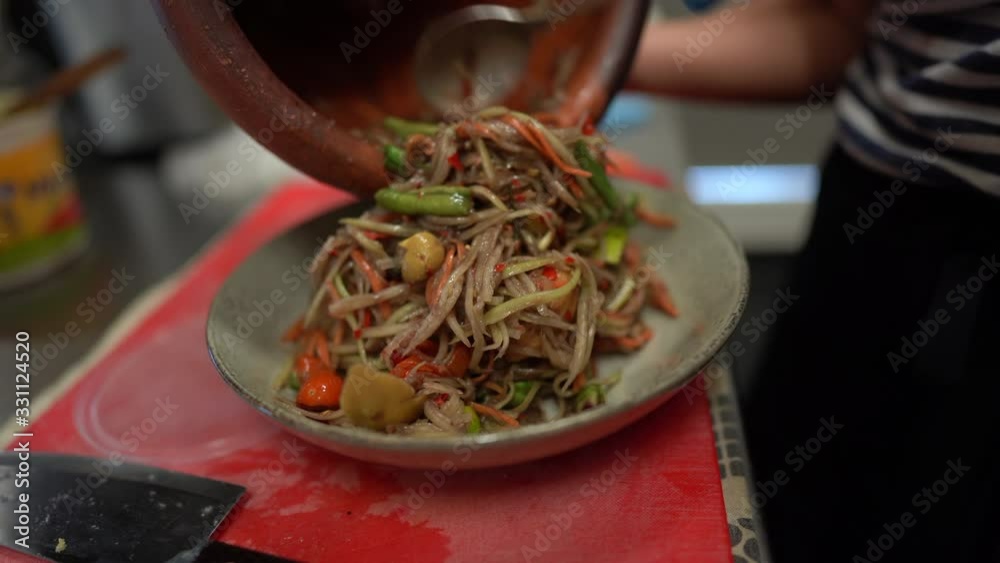 making Thai papaya salad
