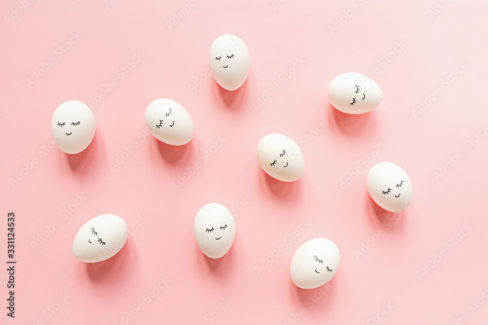 Creative easter eggs with cute face and sleepy eyes on pastel pink background. Happy Easter concept. Flat lay, top view, mockup, template, overhead, copy space Creative easter eggs with cute face and sleepy eyes on pastel pink background. Happy Easter concept. Flat lay, top view, mockup, template, overhead, copy space