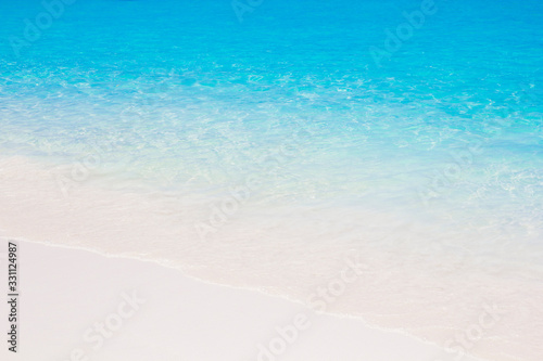 blue sea water waves on white sand beach Beautiful blue sea beach with white sand