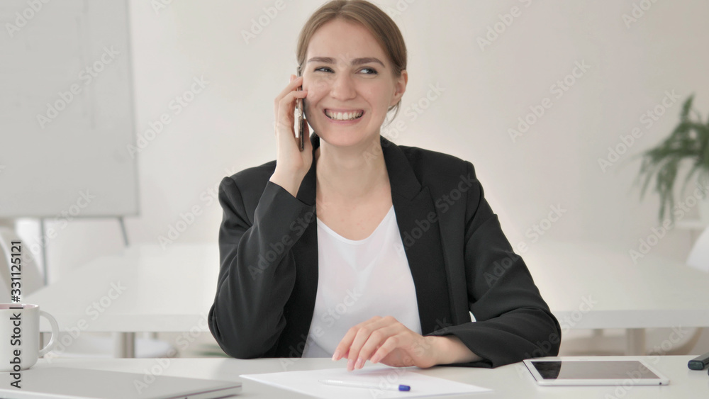 Serious Young Businesswoman in Office Looking at Camera Serious Young Businesswoman in Office Looking at Camera