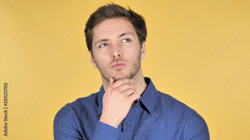 Casual Young Man Upset by Failure on Yellow Background Casual Young Man Upset by Failure on Yellow Background