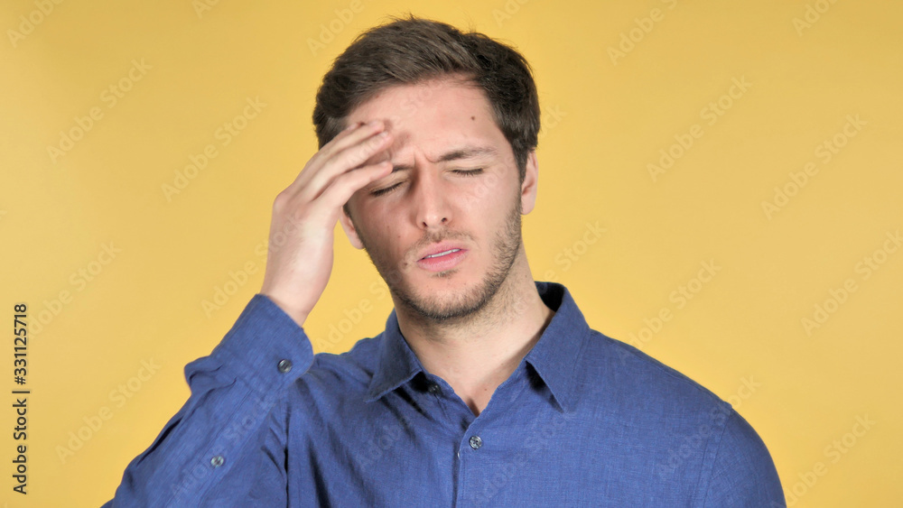 Casual Young Man with Headache on Yellow Background Casual Young Man with Headache on Yellow Background