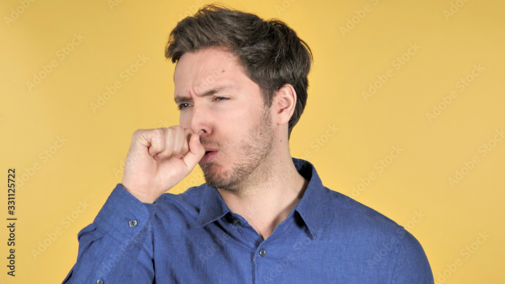 Casual Young Man Coughing on Yellow Background Casual Young Man Coughing on Yellow Background