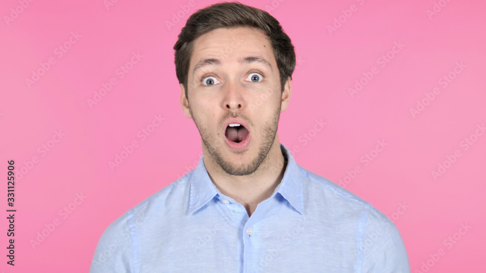 Surprised Young Man Wondering on Pink Background Surprised Young Man Wondering on Pink Background